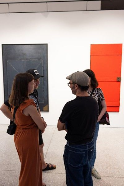 Obiskovalci si ogledujejo slike v Mali galeriji Banke Slovenije