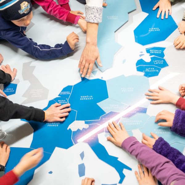 Educational day at the Bank of Slovenia Museum, kindergarten children in front of a euro area jigsaw puzzle